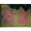 Aerial view of a soccer  pitch with people playing soccer on it - in warm morning sun, casting long shadows