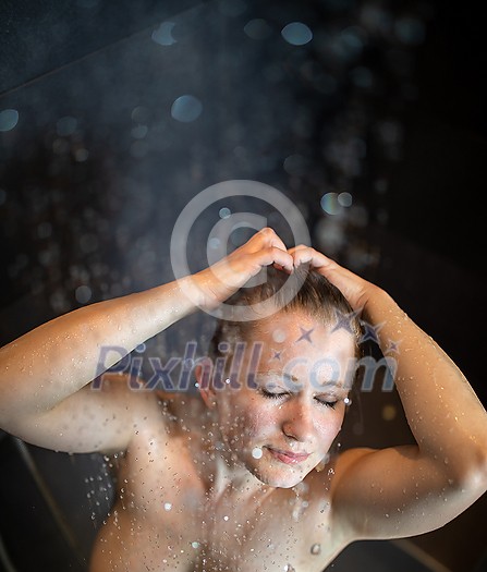 Pretty,young woman taking a long hot shower in a modern bathroom Pretty,young woman taking a long hot shower in a modern bathroom