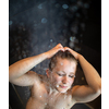 Pretty,young woman taking a long hot shower in a modern bathroom