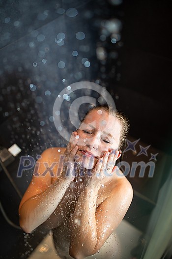 Pretty,young woman taking a long hot shower in a modern bathroom Pretty,young woman taking a long hot shower in a modern bathroom