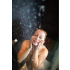 Pretty,young woman taking a long hot shower in a modern bathroom