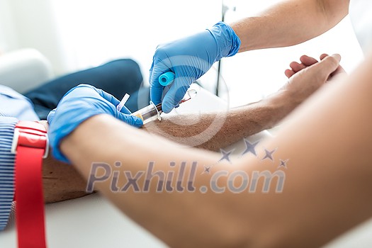 Senior man having a blood test done by a nurse Senior man having a blood test done by a nurse