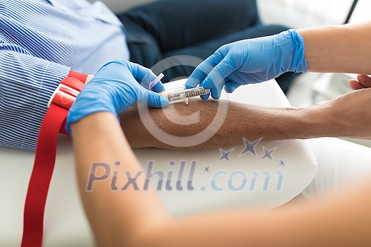 Senior man having a blood test done by a nurse Senior man having a blood test done by a nurse