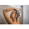 Pretty, young woman taking a long hot shower washing her hair in a modern design bathroom