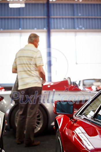 Old cars auction - People viewing cars on sale during an expensive old cars auction Old cars auction - People viewing cars on sale during an expensive old cars auction