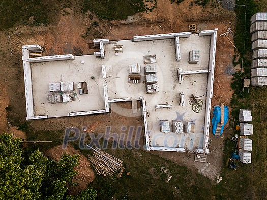 Aerial image of a new family house being built. New private housing development construction in rural countryside aerial view.