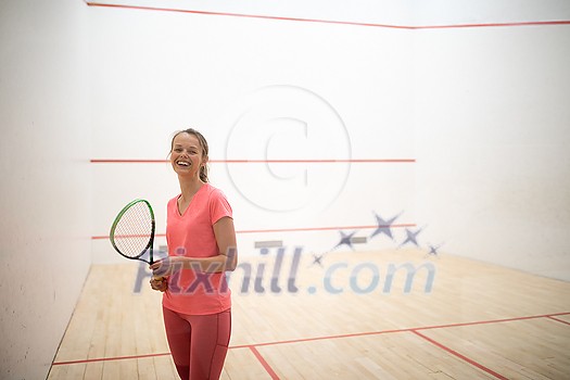 Pretty, female squash player on a squash court (motion blurred image; color toned image) Pretty, female squash player on a squash court (motion blurred image; color toned image)