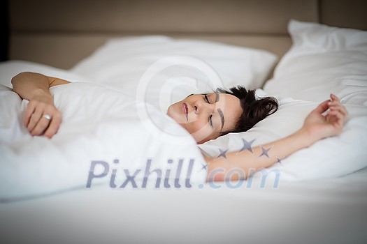 Beautiful young woman sleeping on bed at bedroom Beautiful young woman sleeping on bed at bedroom