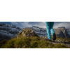 Pretty, young female hiker walking in high mountains (shallow DOF)