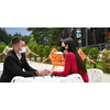 couple with protective medical mask  having coffee break in a restaurant, new normal coronavirus concept