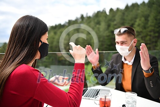 couple with protective medical mask having coffee break in a restaurant, new normal coronavirus concept couple with protective medical mask having coffee break in a restaurant, new normal coronavirus concept