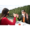 couple with protective medical mask  having coffee break in a restaurant, new normal coronavirus concept