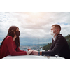 couple with protective medical mask  having coffee break in a restaurant, new normal coronavirus concept