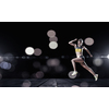 Young woman athlete running fast on dark background 