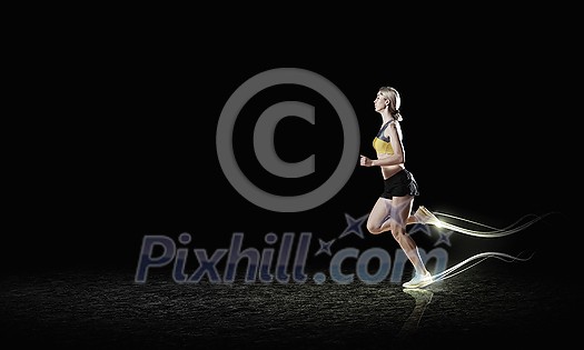 Young woman athlete running fast on dark background Young woman athlete running fast on dark background