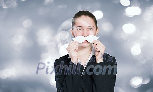 Happy cute girl trying male paper mustache Happy cute girl trying male paper mustache