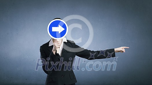 Unrecognizable businesswoman hiding her face behind mask and showing direction Unrecognizable businesswoman hiding her face behind mask and showing direction