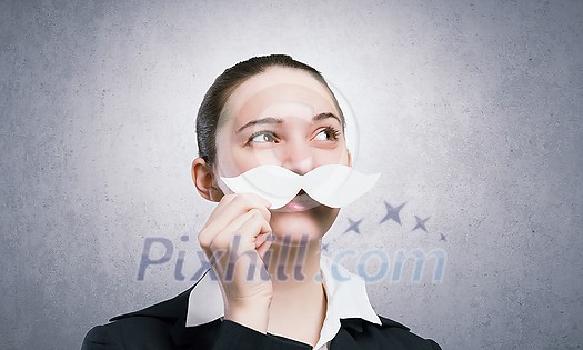 Happy cute girl trying male paper mustache Happy cute girl trying male paper mustache