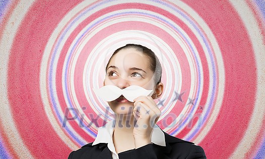 Happy cute girl trying male paper mustache Happy cute girl trying male paper mustache