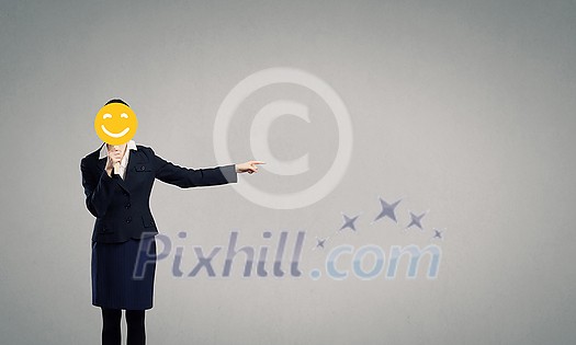 Unrecognizable businesswoman hiding her face behind mask and showing direction Unrecognizable businesswoman hiding her face behind mask and showing direction