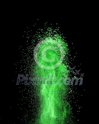 Creative vertical powder splash or explosion in a green color on a black background, copy space. Creative vertical powder splash or explosion in a green color on a black background, copy space.