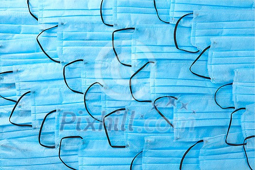 Medical background from medical antibacterial protective blue face masks. Concept of prevention from respiratory sickness and viruses. Medical background from medical antibacterial protective blue face masks. Concept of prevention from respiratory sickness and viruses.