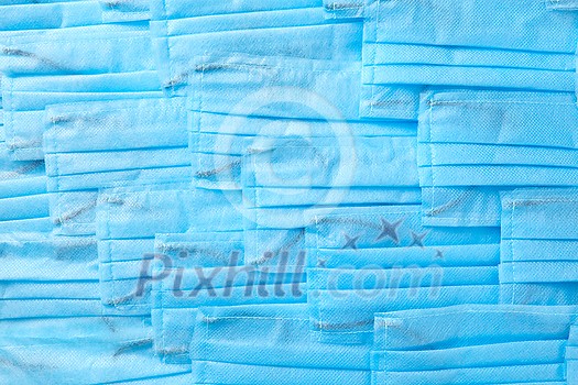 Creative background from medical antibacterial protective blue face masks. Concept of prevention from respiratory sickness and viruses. Creative background from medical antibacterial protective blue face masks. Concept of prevention from respiratory sickness and viruses.
