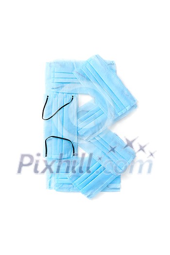 Capital letter B handmade from medical antibacterial protective blue face masks on a white background, copy space. Creative alphabet for making up new words. Capital letter B handmade from medical antibacterial protective blue face masks on a white background, copy space. Creative alphabet for making up new words.