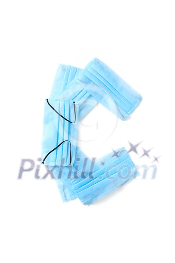 Capital letter C handmade from medical antibacterial protective blue face masks on a white background, copy space. Creative alphabet for making up new words. Capital letter C handmade from medical antibacterial protective blue face masks on a white background, copy space. Creative alphabet for making up new words.