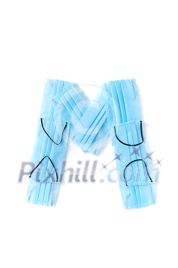 Capital letter M handmade from medical antibacterial protective blue face masks on a white background, copy space. Creative alphabet for making up new words. Capital letter M handmade from medical antibacterial protective blue face masks on a white background, copy space. Creative alphabet for making up new words.