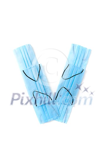 Capital letter V handmade from medical antibacterial protective blue face masks on a white background, copy space. Creative alphabet for making up new words. Capital letter V handmade from medical antibacterial protective blue face masks on a white background, copy space. Creative alphabet for making up new words.