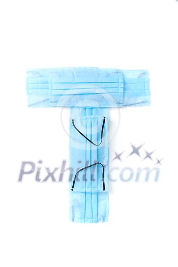 Capital letter T handmade from medical antibacterial protective blue face masks on a white background, copy space. Creative alphabet for making up new words. Capital letter T handmade from medical antibacterial protective blue face masks on a white background, copy space. Creative alphabet for making up new words.