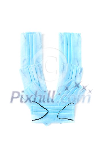 Capital letter U handmade from medical antibacterial protective blue face masks on a white background, copy space. Creative alphabet for making up new words. Capital letter U handmade from medical antibacterial protective blue face masks on a white background, copy space. Creative alphabet for making up new words.