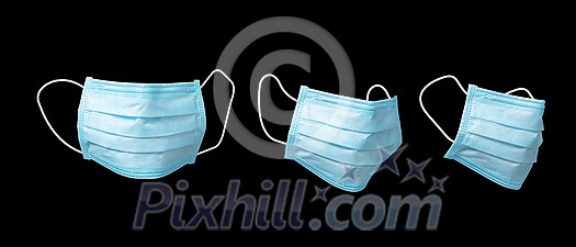 Creative set from three medical antibacterial blue face masks for protection from infections on a black background, copy space. Concept of prevention from respiratory sickness and viruses. Creative set from three medical antibacterial blue face masks for protection from infections on a black background, copy space. Concept of prevention from respiratory sickness and viruses.
