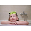 little girl with snorkel goggles in the tub while taking a bath in the bathtub, kids hygiene concept and summer vacation in corona virus stay at home