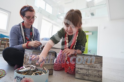 Mother and little girl daughter playing with jewelry while staying at home in coronavirus quarantine