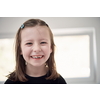 Funny little girl without tooth smiles showing gap close up