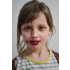 Cute little preschool girl playing with mommy's make up. Fashion experiment little child applying makeup lipstick and shadow on face, staying at home in corona virus quarantine.