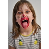 Cute little preschool girl playing with mommy's make up. Fashion experiment little child applying makeup lipstick and shadow on face, staying at home in corona virus quarantine.