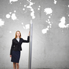 Young businesswoman with big pencil in hands