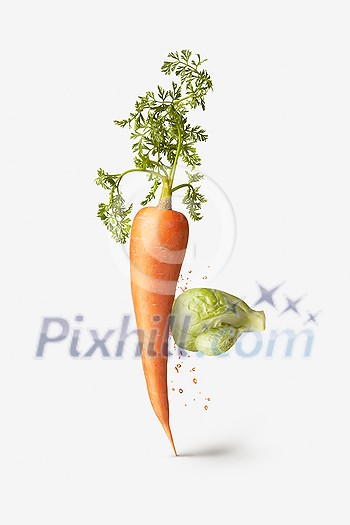 Creative vegetarian composition from fresh natural organic cabbage in the form of boxing glove punching vegetable carrot with splash on a white background, copy space. Vegan healthy food concept. Creative vegetarian composition from fresh natural organic cabbage in the form of boxing glove punching vegetable carrot with splash on a white background, copy space. Vegan healthy food concept.