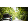 Handsome young man calling for assistance with his car broken down by the roadside