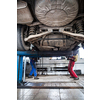 Inside a garage - two mechanics working on a car, changing wheels, doing maintenance (shallow DOF; color toned image)