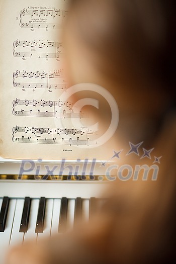 Playing Piano (shallow DOF; color toned image) Playing Piano (shallow DOF; color toned image)
