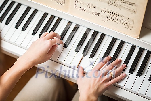 Playing Piano (shallow DOF; color toned image) Playing Piano (shallow DOF; color toned image)