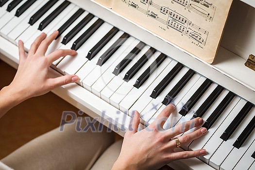 Playing Piano (shallow DOF; color toned image) Playing Piano (shallow DOF; color toned image)
