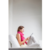 Pretty, young woman woman using digital tablet while relaxing on sofa at home. Attractive young woman wearing casual clothes.