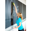 Pretty, young college/university student writing on the chalkboard/blackboa rd during a math class (color toned image; shallow DOF)