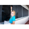 Pretty, young college/university student writing on the chalkboard/blackboa rd during a math class (color toned image; shallow DOF)