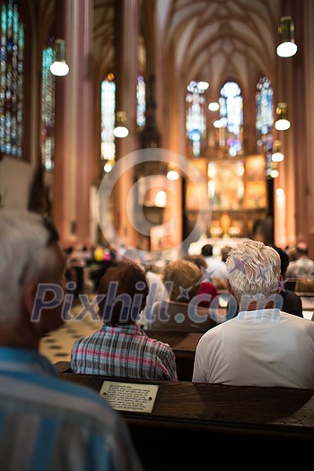 People in a church during a mass People in a church during a mass